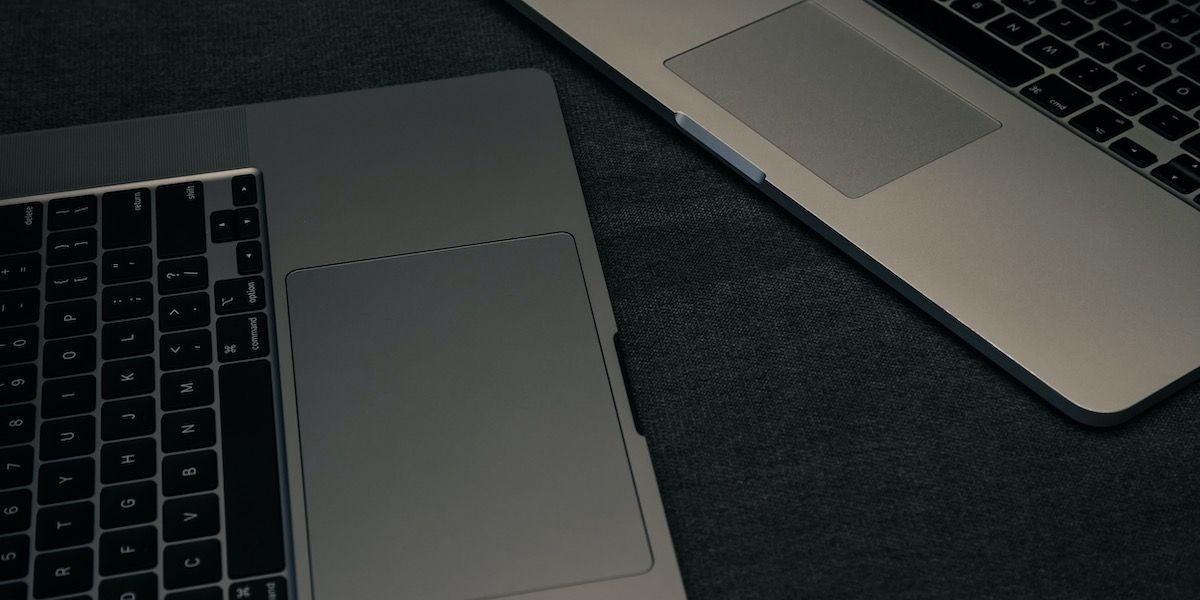 deux macbooks avec focus sur le trackpad